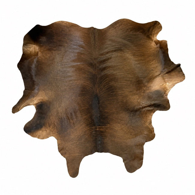 Genuine brown cowhide area rug, full hide shown from above on a white studio background.