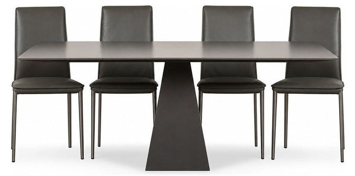 Gray Gunnar dining table with a long tempered glass top and mid-century frame.