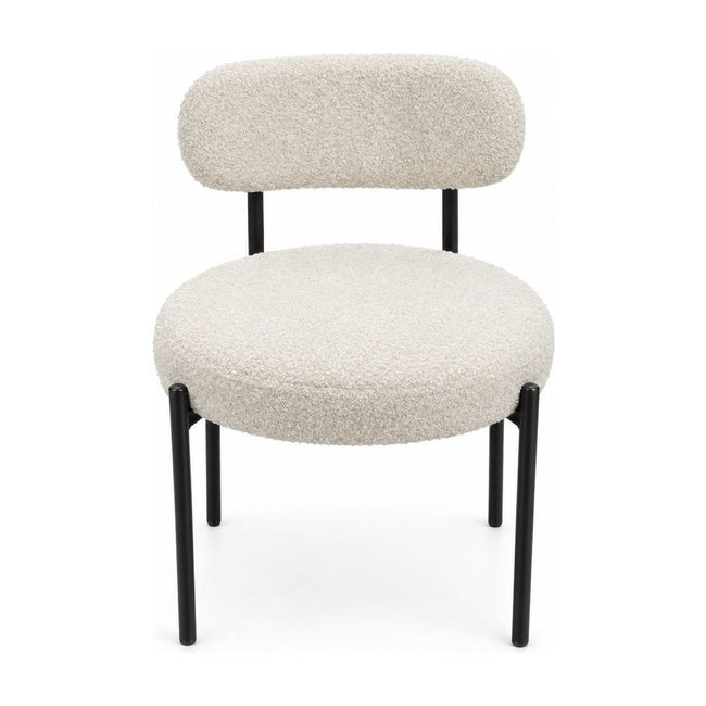Cream boucle dining chairs with a looped texture and compact seat.
