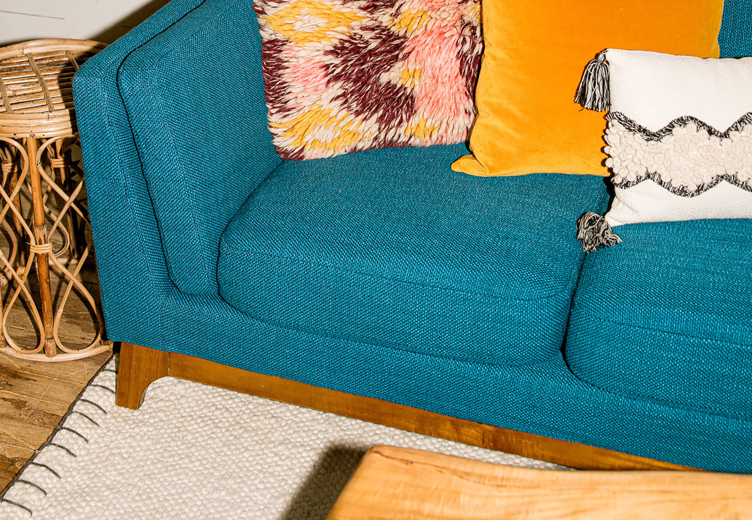 Custom teal sofa with colorful accent pillows at Whats New Furniture Portland Oregon