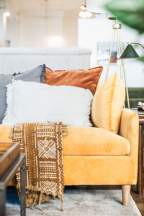 Mid-century modern sofa in a vintage-inspired Portland furniture store showroom.
