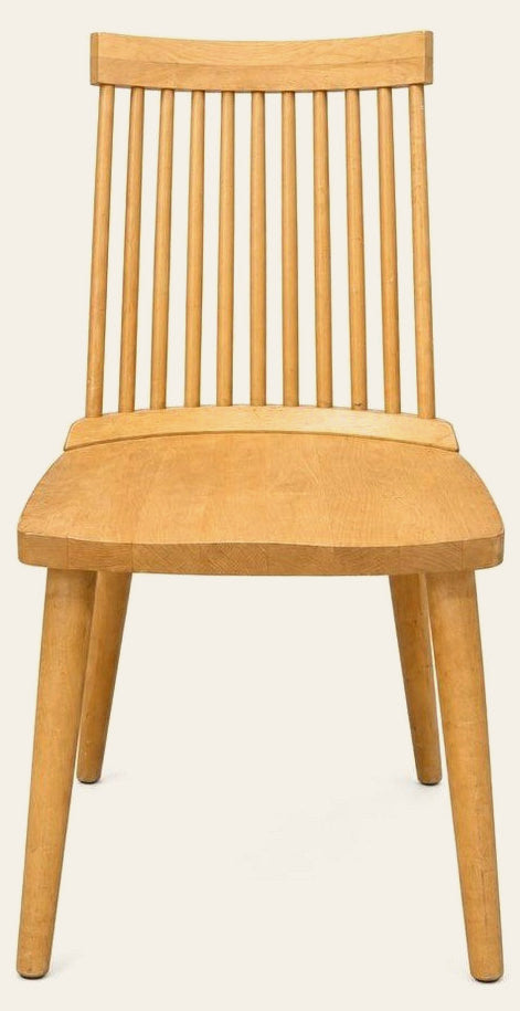Blonde dining room chairs with tapered wood frames, shown as a set of four.