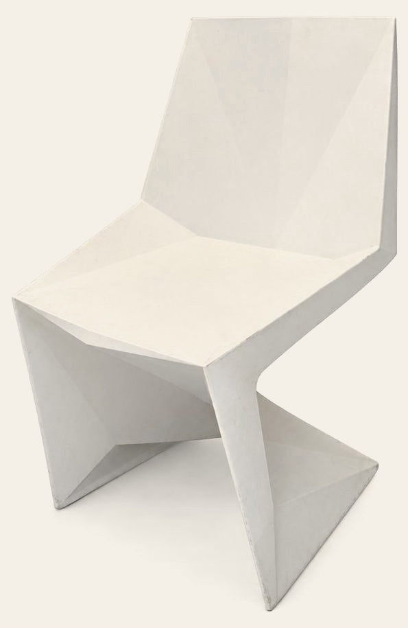 White geometric dining chair with an angular molded shell by VONDOM