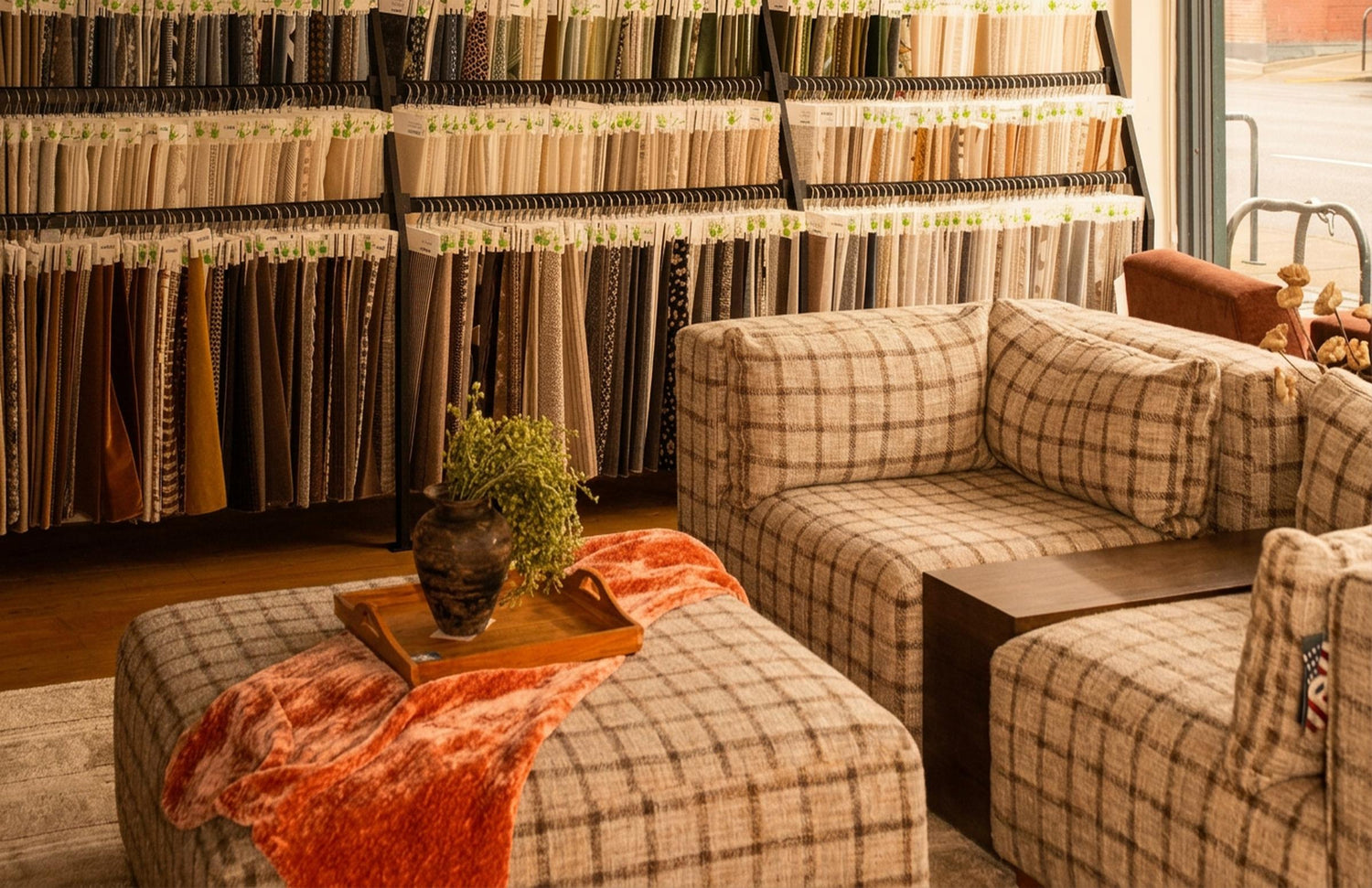 Colorful fabric swatch wall and modern plaid sofa at What's New Furniture Portland showroom - customizable sofas and modern furniture in Portland Oregon