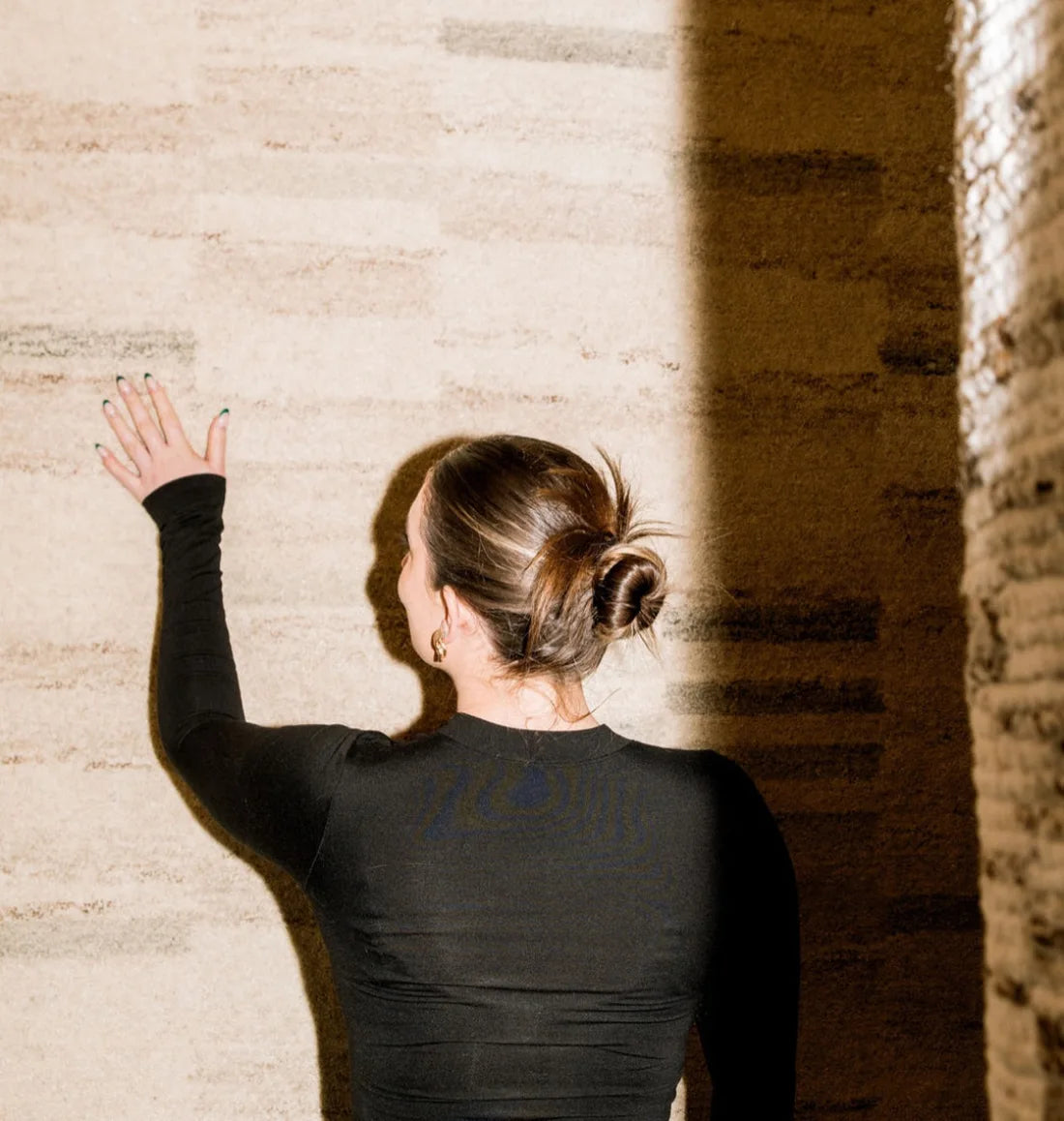 A designer exploring rug samples at What's New Furniture