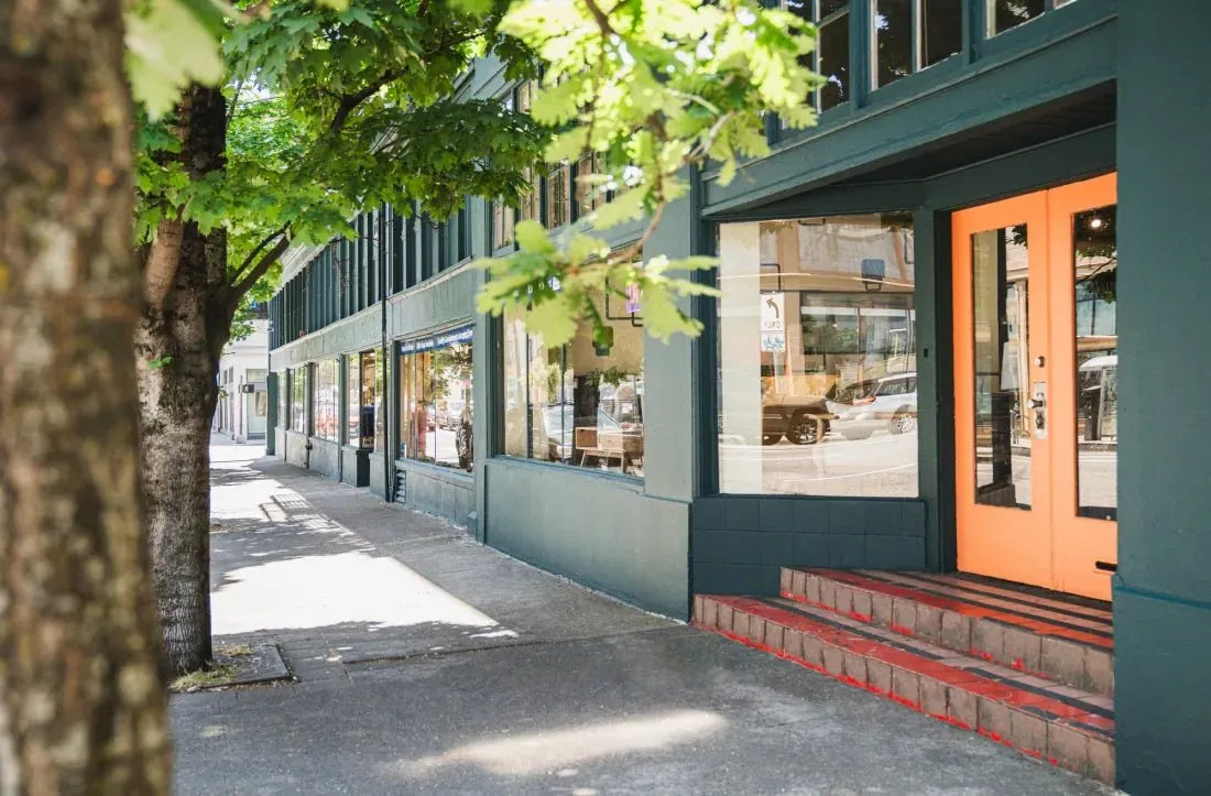 What's New Furniture Portland storefront, a teal building with orange doors