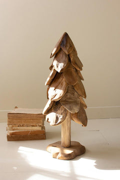 Small rustic teak Christmas tree with layered carved petals on a freeform base in a sunlit room - carved wood holiday decor by Kalalou - Whats New Furniture Portland OR