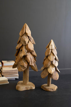 Large and small rustic teak Christmas trees shown together against a dark grey wall - carved wood holiday decor by Kalalou - Whats New Furniture Portland OR