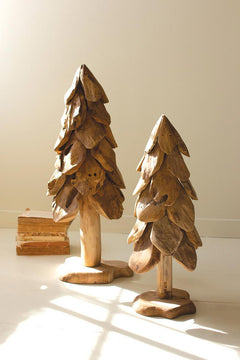 Large rustic teak Christmas tree beside the smaller size in sunlight showing carved petal layers - carved wood holiday decor by Kalalou - Whats New Furniture Portland OR