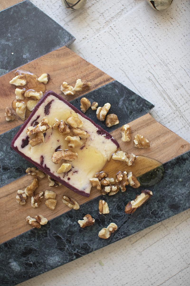 Close-up of the marble and acacia bands on the Christmas tree cutting board with cheese and walnuts - holiday serveware by Kalalou - Whats New Furniture Portland OR