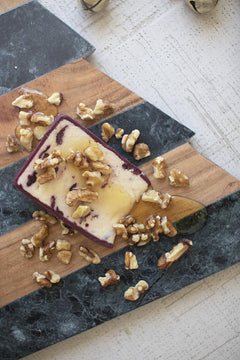 Close-up of the marble and acacia bands on the Christmas tree cutting board with cheese and walnuts - holiday serveware by Kalalou - Whats New Furniture Portland OR