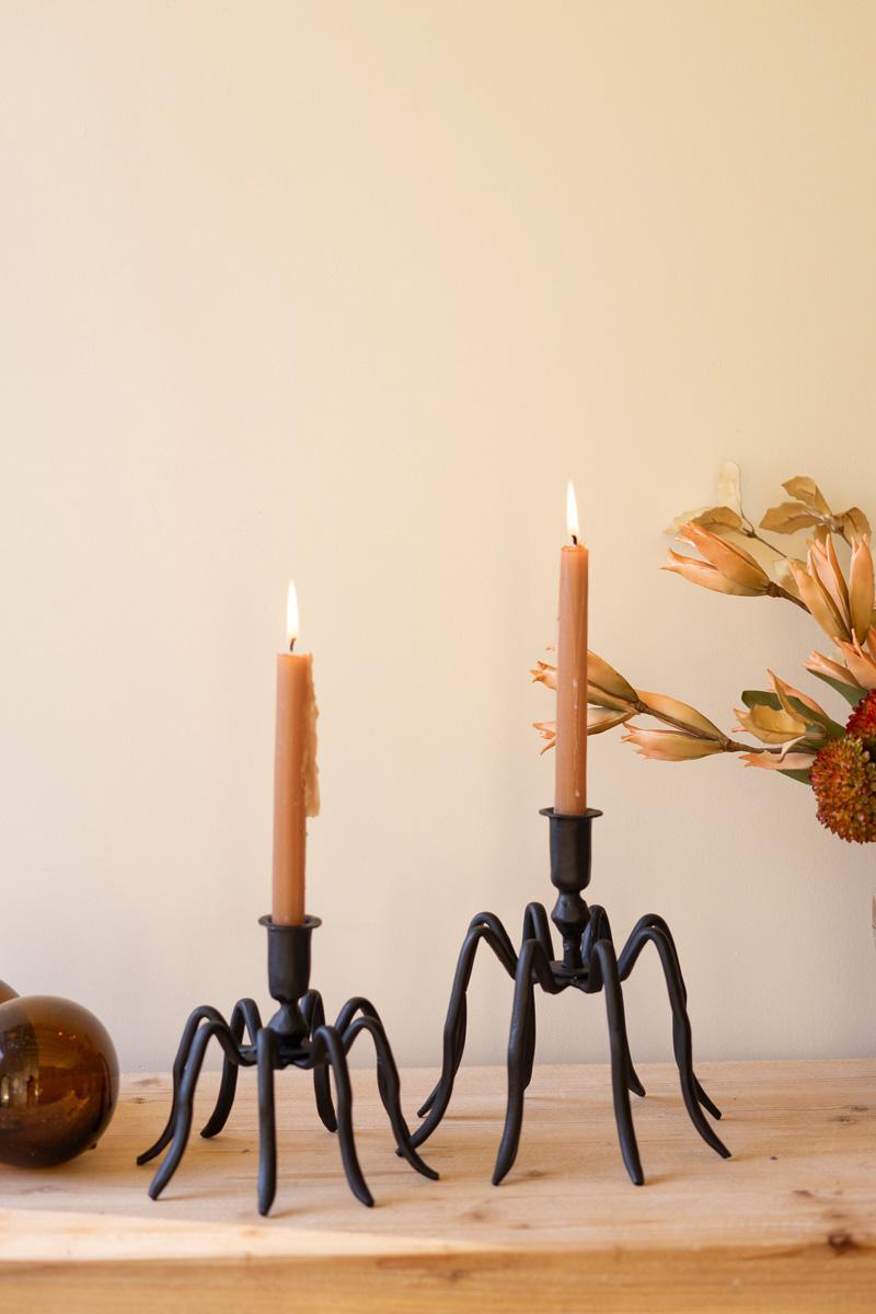 Pair of cast iron spider taper candle holders with lit candles on a wood ledge - forged black candle holders by Kalalou - Whats New Furniture Portland OR
