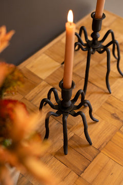 Cast iron spider candle holders on a parquet table with a lit taper and autumn flowers - forged black candle holders by Kalalou - Whats New Furniture Portland OR