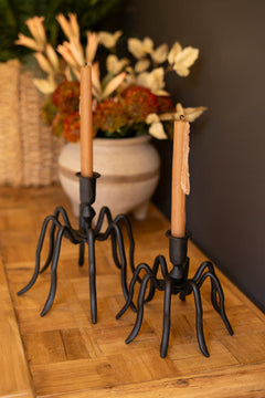 Both cast iron spider candle holders staged beside a woven planter and dried arrangement - forged black candle holders by Kalalou - Whats New Furniture Portland OR