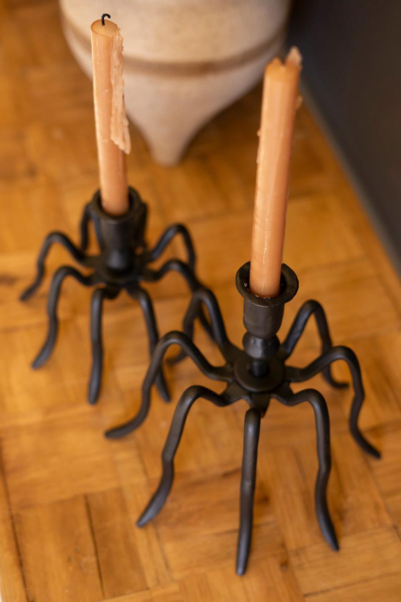 Angled view of the small and large cast iron spider candle holders on parquet wood - forged black candle holders by Kalalou - Whats New Furniture Portland OR