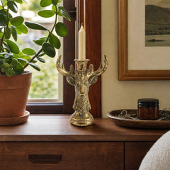 Antique Gold Deer Head Taper Candle Holder styled with a taper on a walnut console by a window in a Portland home - Whats New Furniture