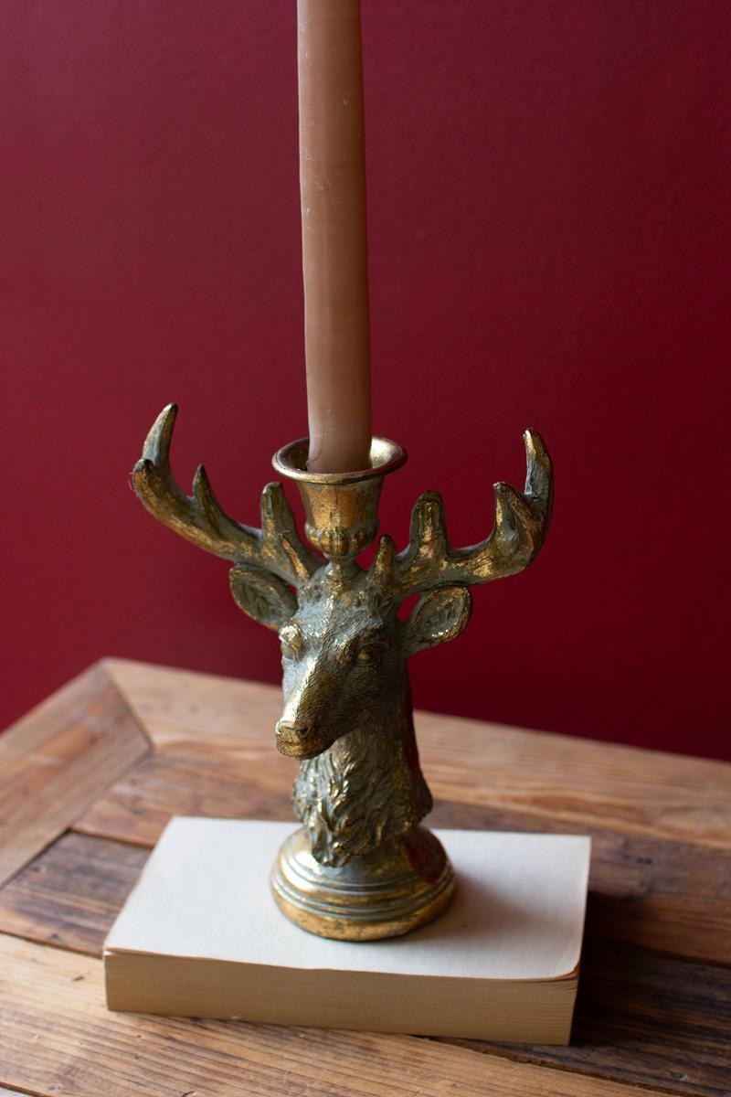 Antique Gold Deer Head Taper Candle Holder styled against a crimson backdrop on reclaimed wood - antique gold deer candle holder by Kalalou - Whats New Furniture Portland OR