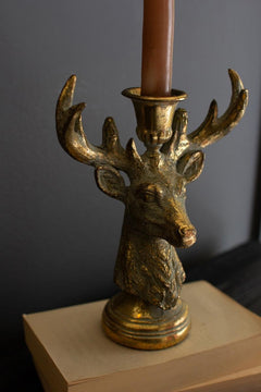 Antique Gold Deer Head Taper Candle Holder styled on a pale oak block showing the stepped base - gold stag taper holder by Kalalou - Whats New Furniture Portland OR