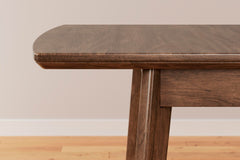 Lyncott Extension Dining Table detail of the self-storing butterfly leaf - Whats New Furniture Portland OR