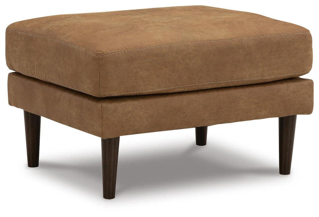 Telora Ottoman in caramel faux leather angled view showing the accent legs - Whats New Furniture Portland OR
