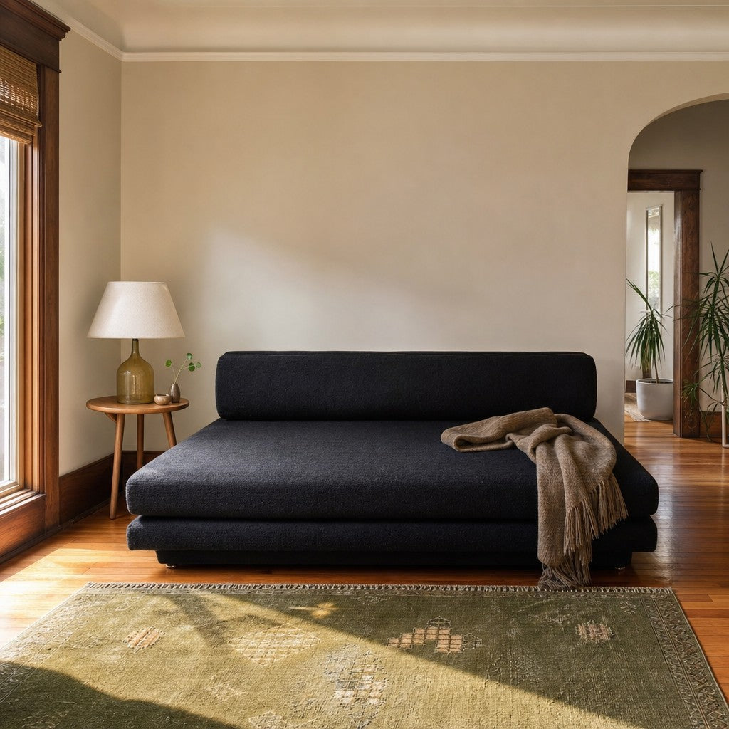 Black upholstered plinth lounge chaise longue with a low, grounded base - view 2