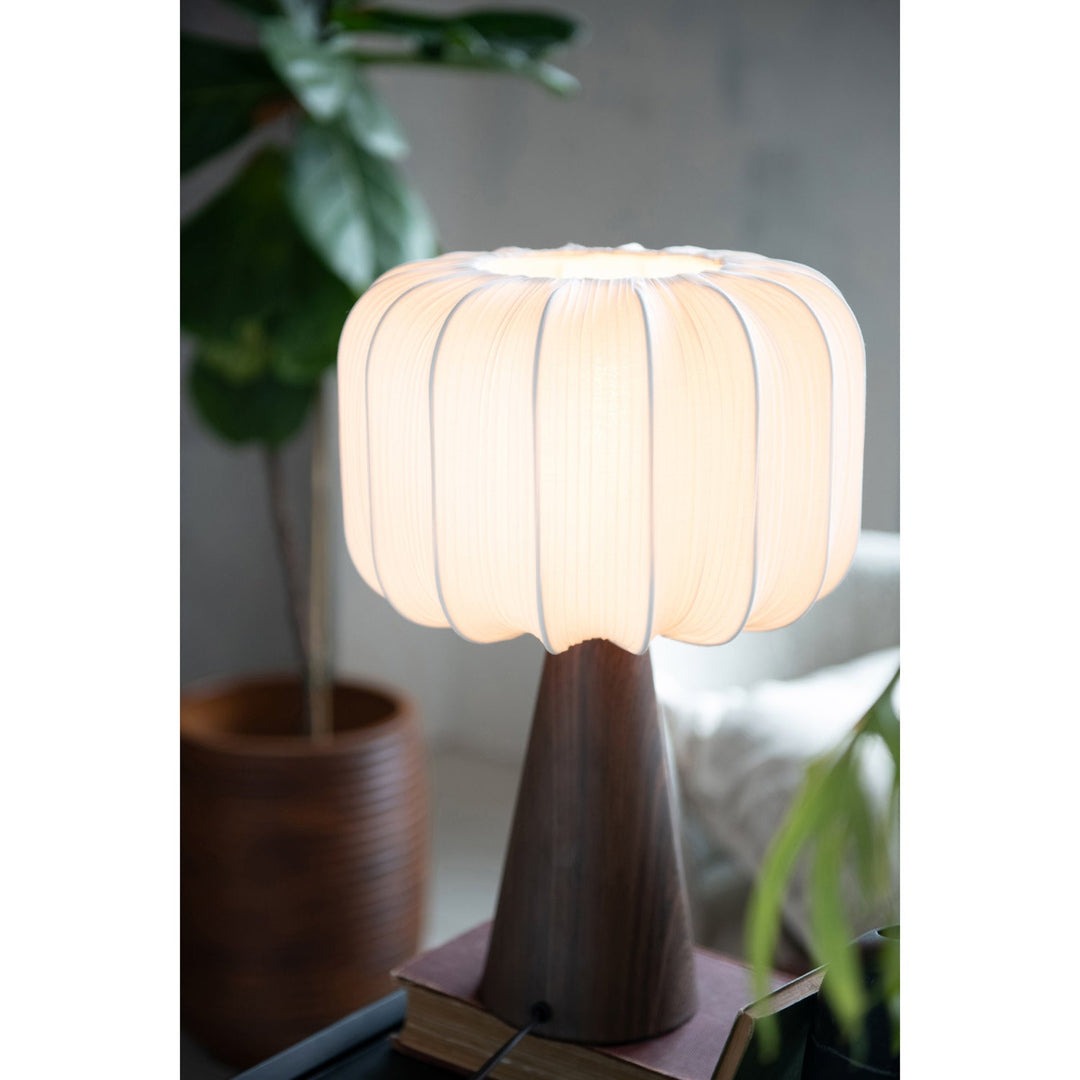 Close-up of the pleated fabric shade glowing warmly when lit showing even lantern-like diffusion - Bloomingville lamp - Whats New Furniture Portland