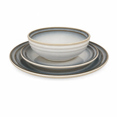 Blue-gray stoneware dinnerware set with bowls, salad plates, and dinner plates for four