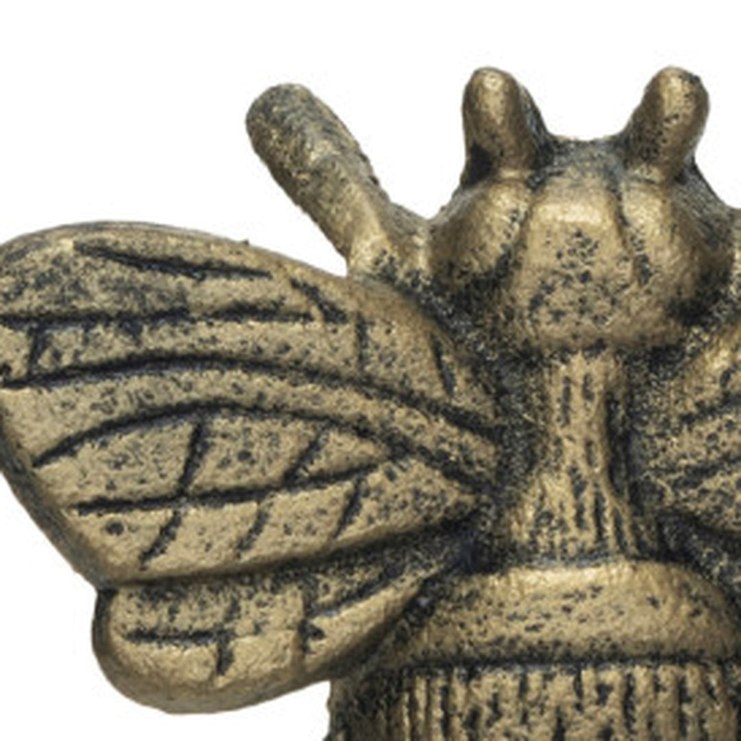 Close-up of the cast wing veining and textured thorax on the distressed gold bee bottle opener - Creative Co-Op - Whats New Furniture Portland OR