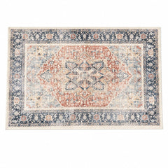 Terracotta and navy accent rug with a geometric woven pattern