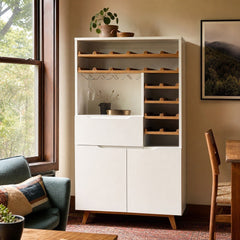 White mid-century Article bar cabinet with a tall slim silhouette and paneled doors. - detail view 1
