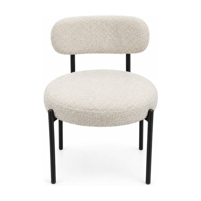 Cream boucle dining chairs with a looped texture and compact seat.
