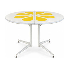 White / Yellow mid-century dining table with a two-tone laminate top and tapered legs.