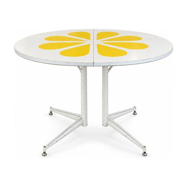 White / Yellow mid-century dining table with a two-tone laminate top and tapered legs.