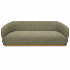 Green mid-century sofa with warm oak trim and clean horizontal lines