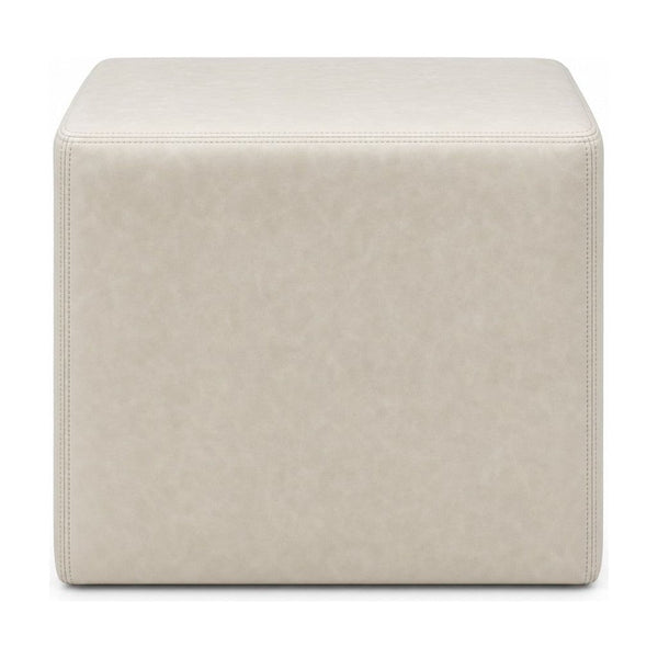 Cream square ottoman with cube silhouette and linen-like upholstery.