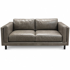 Gray leather sofa with low-slung lines and a hardwood frame by Room and Board