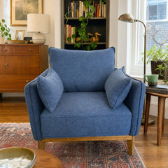 Medium Blue mid-century armchair with a boxy upholstered seat and wood frame. - detail view 1