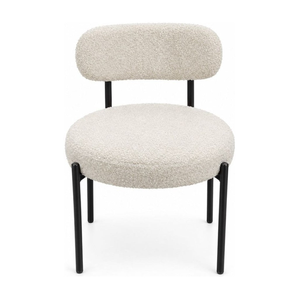 Cream boucle dining chairs with a looped texture and compact seat.