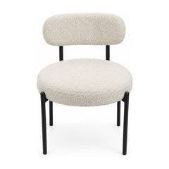 Cream boucle dining chairs with a looped texture and compact seat.