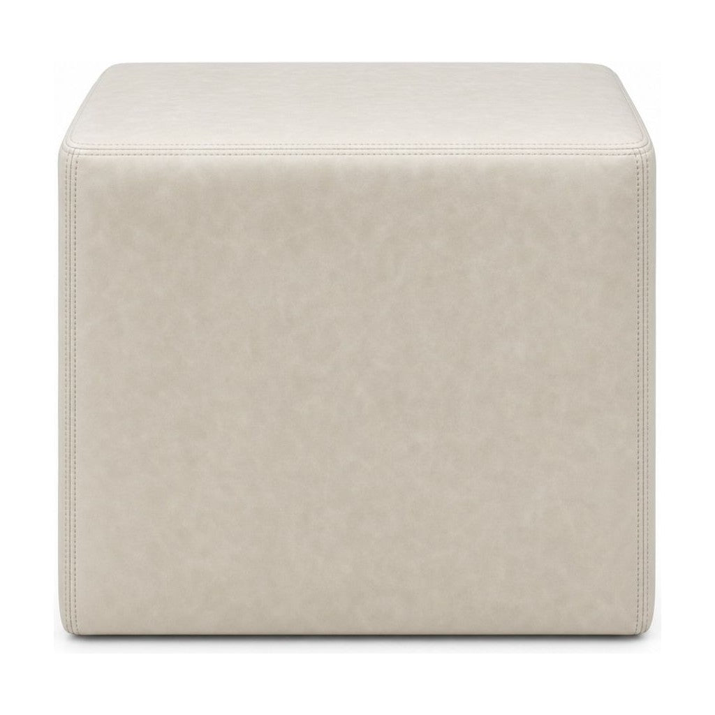 Cream square ottoman with cube silhouette and linen-like upholstery.