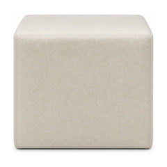 Cream square ottoman with cube silhouette and linen-like upholstery.