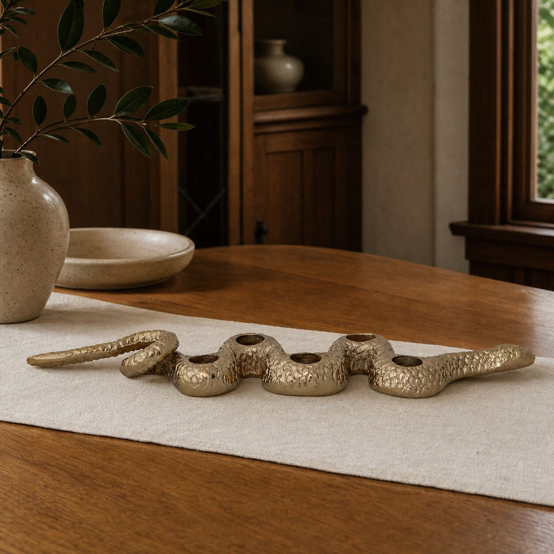 Gold snake taper holder styled on a Portland dining table - Whats New Furniture