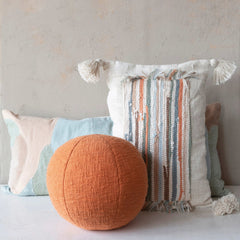 Cotton Blend Patchwork Lumbar Pillow styled against a plaster wall with an orange ball pillow and woven wall hanging in a Portland home - Whats New Furniture