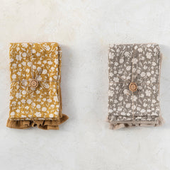 Set of two ruffled cotton tea towels laid flat side by side