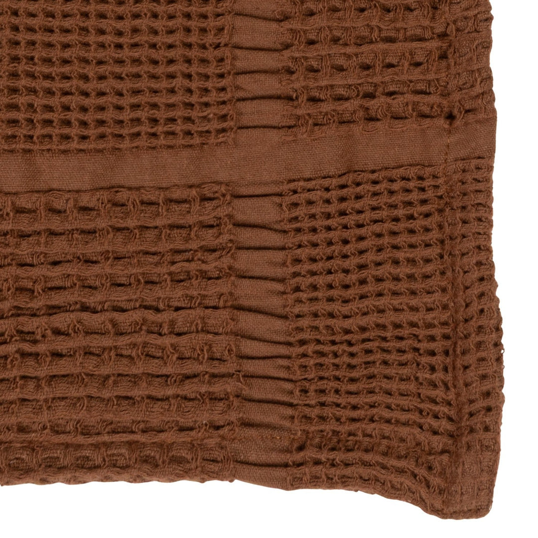Close-up of the waffle weave honeycomb texture and tan grid line on the brown cotton throw - Whats New Furniture Portland OR