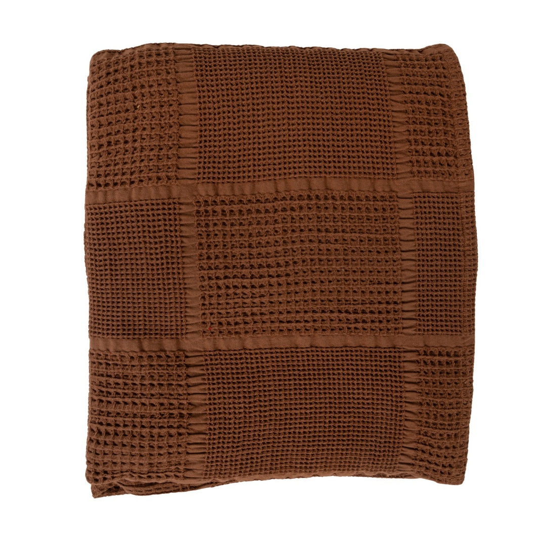 Folded stack of the brown cotton waffle weave throw showing the honeycomb texture depth - Creative Co-Op throw - Whats New Furniture Portland