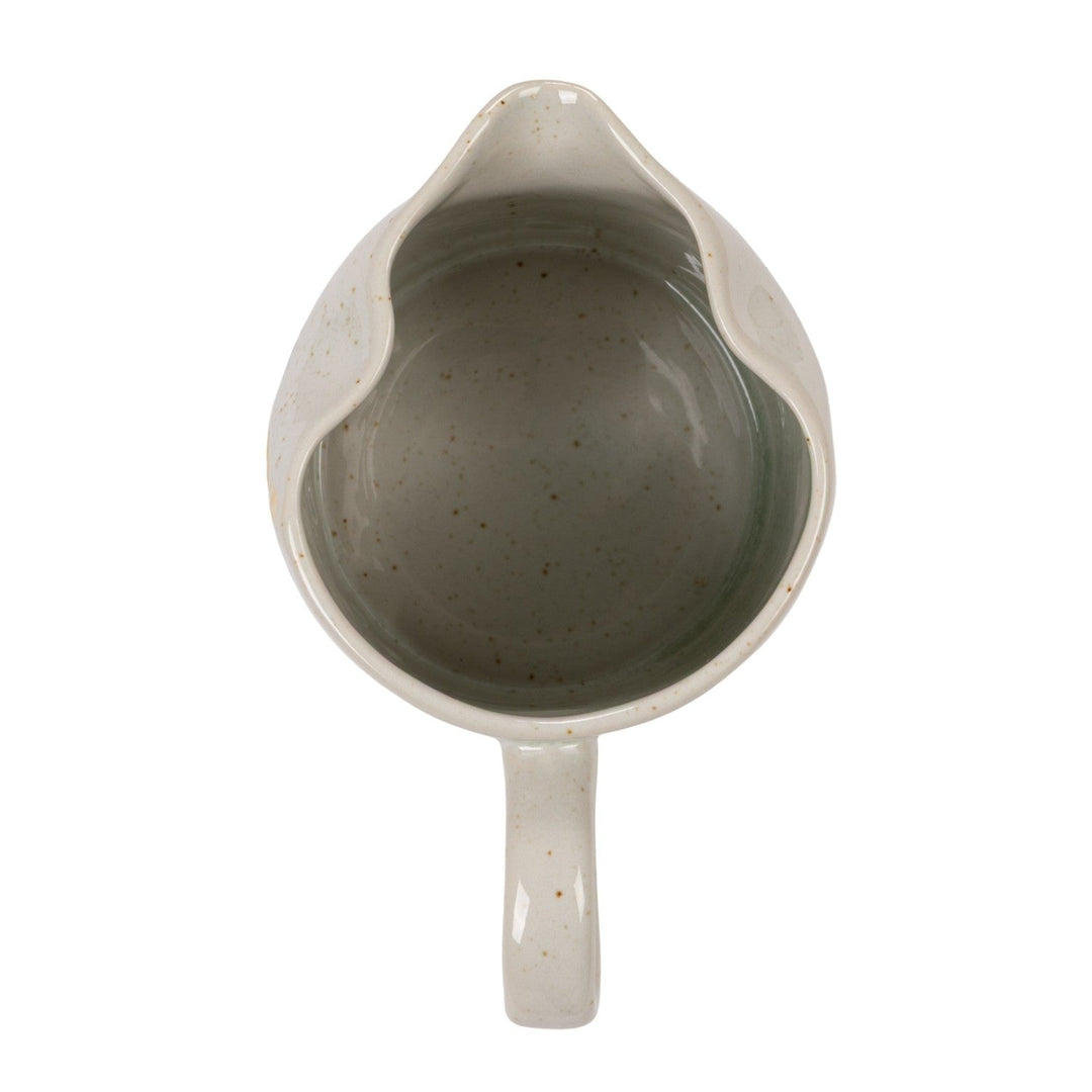 Overhead view of the creamer showing the sage glazed interior and pour spout