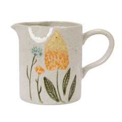 Front of the hand-painted floral stoneware creamer with handle