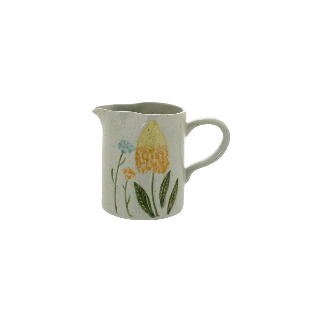 Hand-painted stoneware creamer with a yellow tulip and blue wildflowers