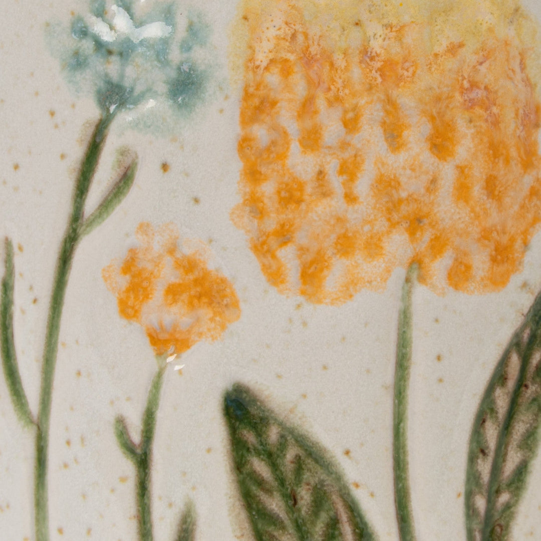 Close detail of the hand-painted flowers and reactive glaze